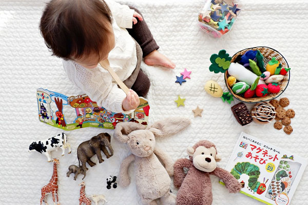 toddler playing with many toys